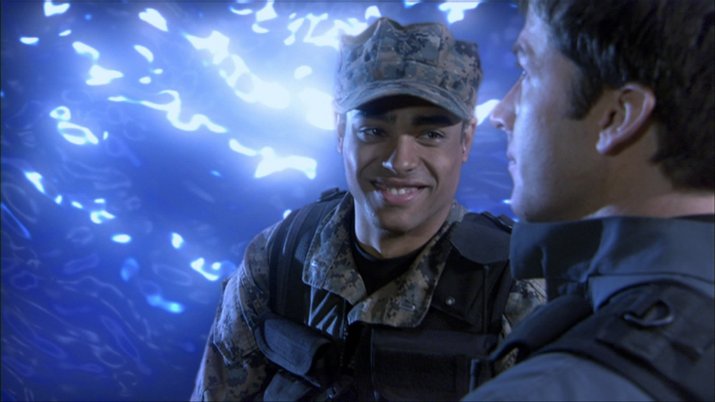 Lt. Aiden Ford (Rainbow Sun Francks) gleefully stands in front of the Stargate.