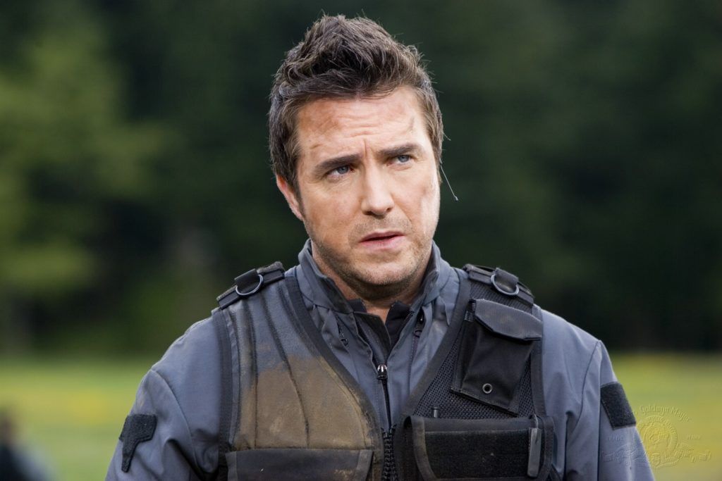 Dr. Carson Beckett (Paul McGillion) splattered with mud in the field.
