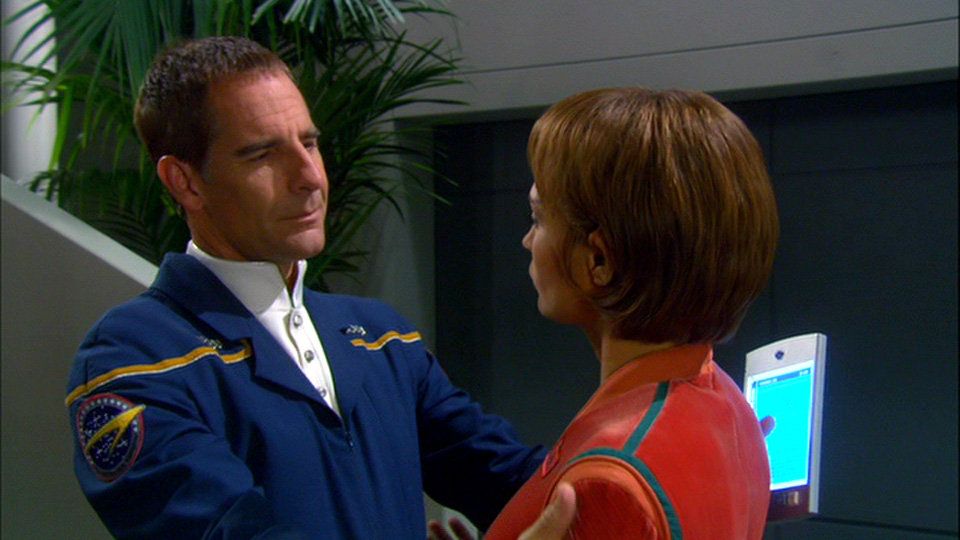 Archer (Scott Bakula) clasps T’Pol (Jolene Blalock) by the shoulders.
