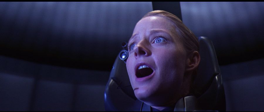 Dr. Ellie Arroway (Jodie Foster) sits with eyes wide and mouth open.