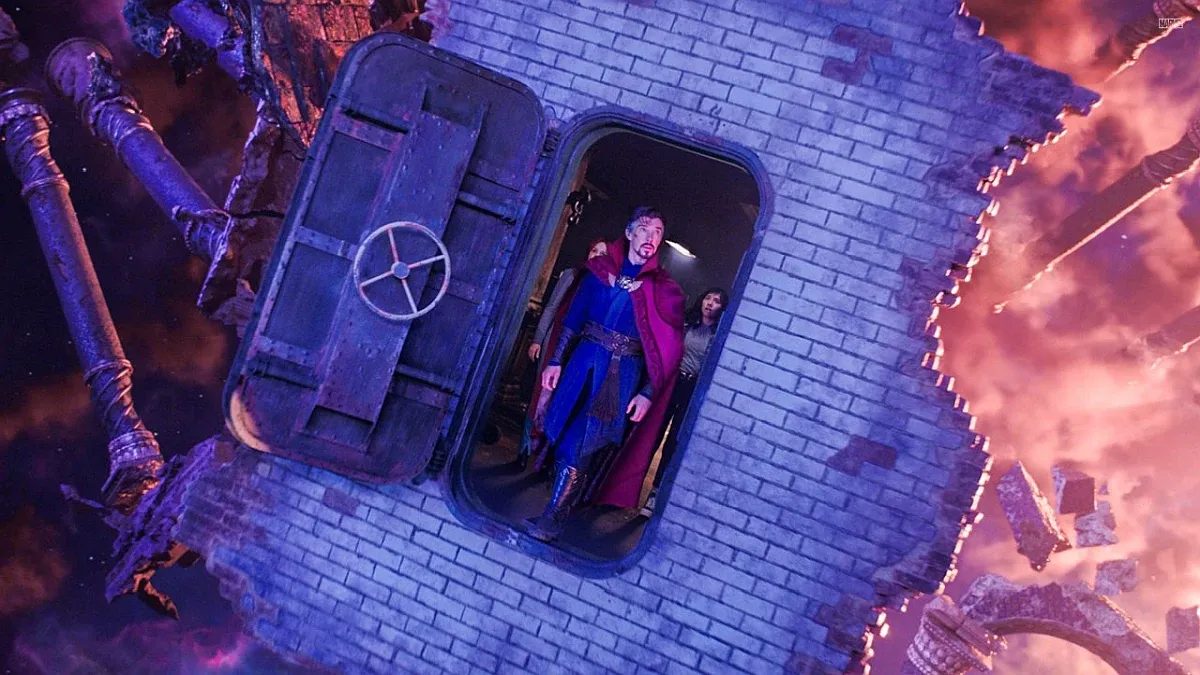 Doctor Strange (Benedict Cumberbatch) and America Chavez (Xochitl Gomez) look through a door that is floating in space.