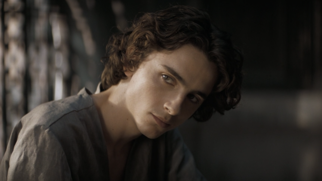 Paul Atreides (Timothée Chalamet) wearing a charcoal colored shirt. He looks to the side.