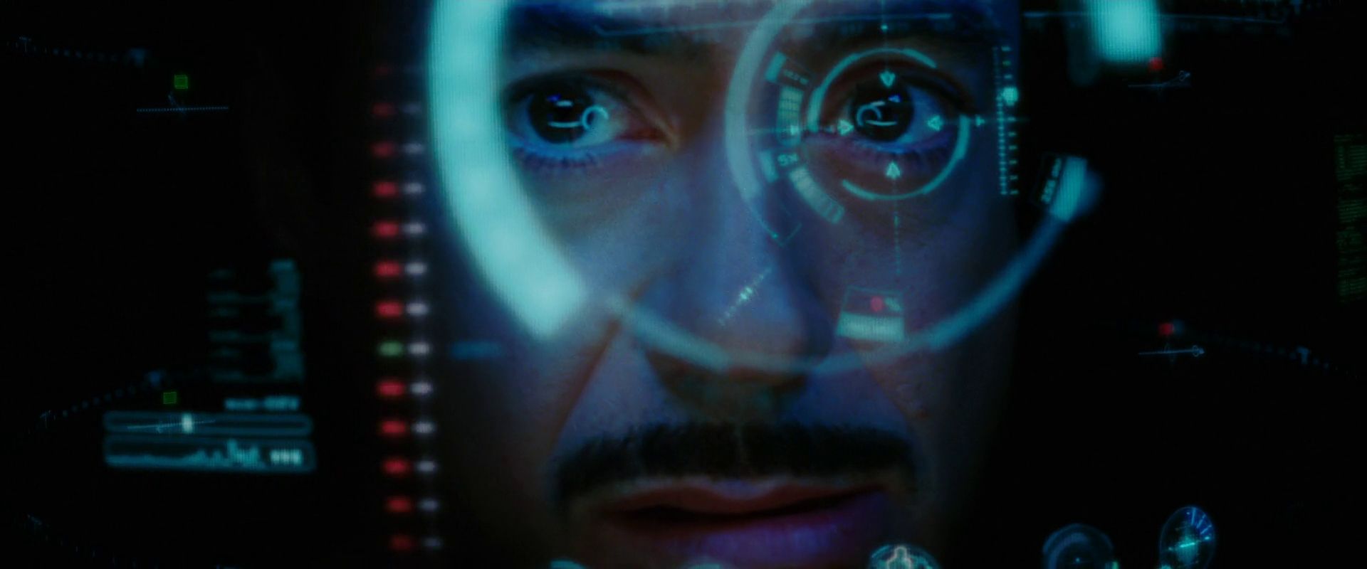 A close up of Tony Stark’s face within the Iron Man suit through the HUD.