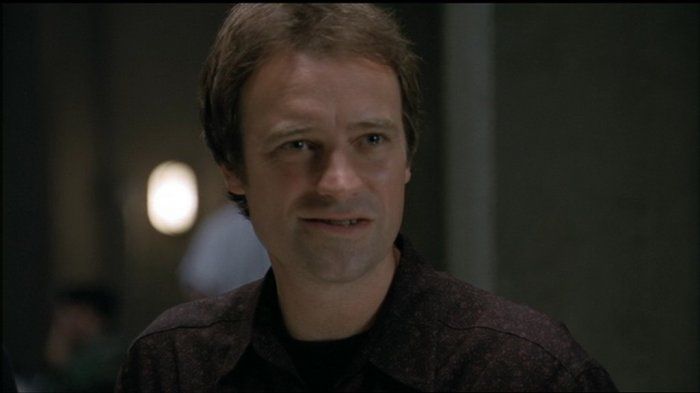 A younger Rodney McKay (David Hewlett) smirks.