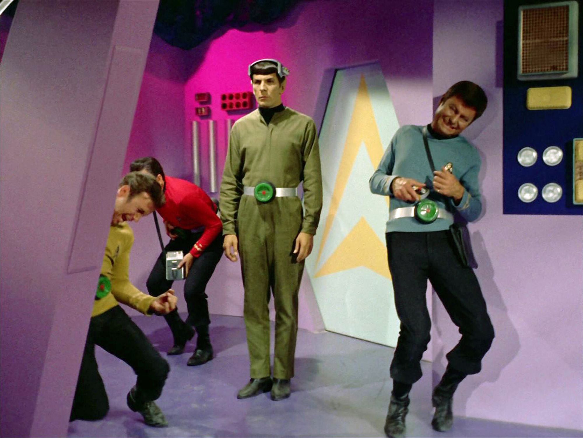Spock (Leonard Nimoy) stands rigidly whilst the rest of the crew writhe in agony.
