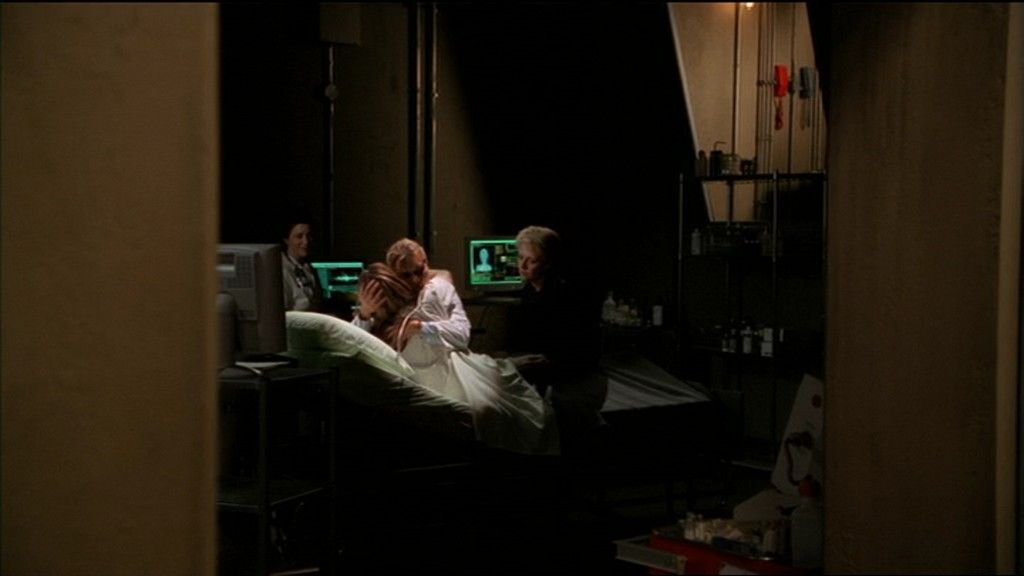 Janet Frasier (Teryl Rothery) embraces Cassandra (Colleen Rennison) in her bed.