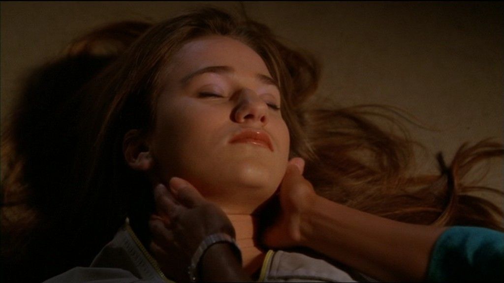 Cassandra (Colleen Rennison) unconscious on the floor.