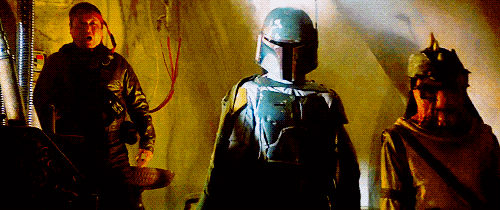 Boba Fett raises his blaster in a smooth motion as the men either side of him duck for cover.