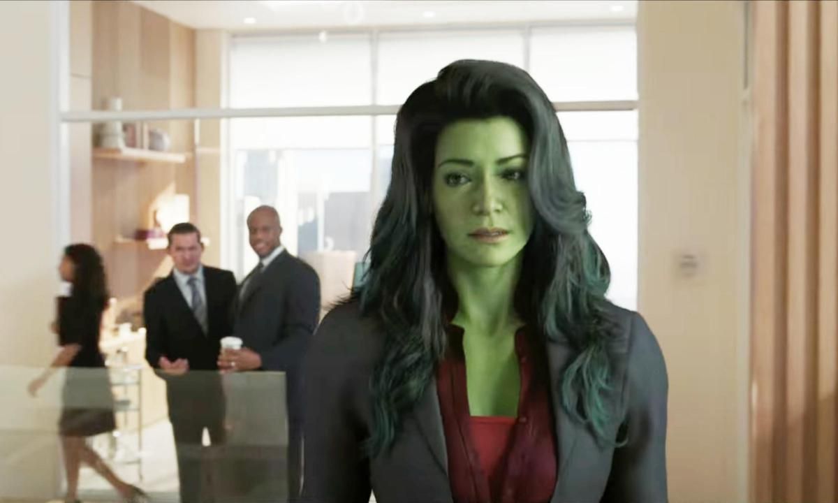 Jennifer Walters (Tatiana Maslany) looks towards the camera. She's wearing a suit over her She-Hulk form.