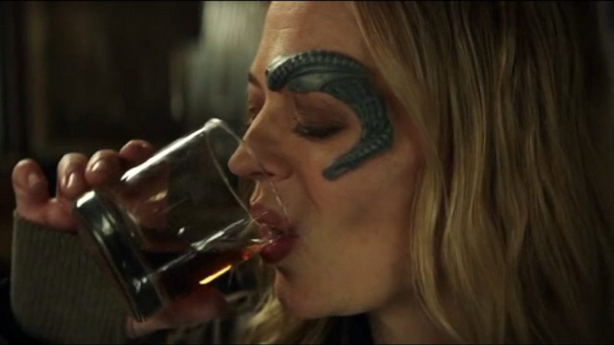 Seven of Nine (Jeri Ryan) lifts a glass of spirits to her lips.