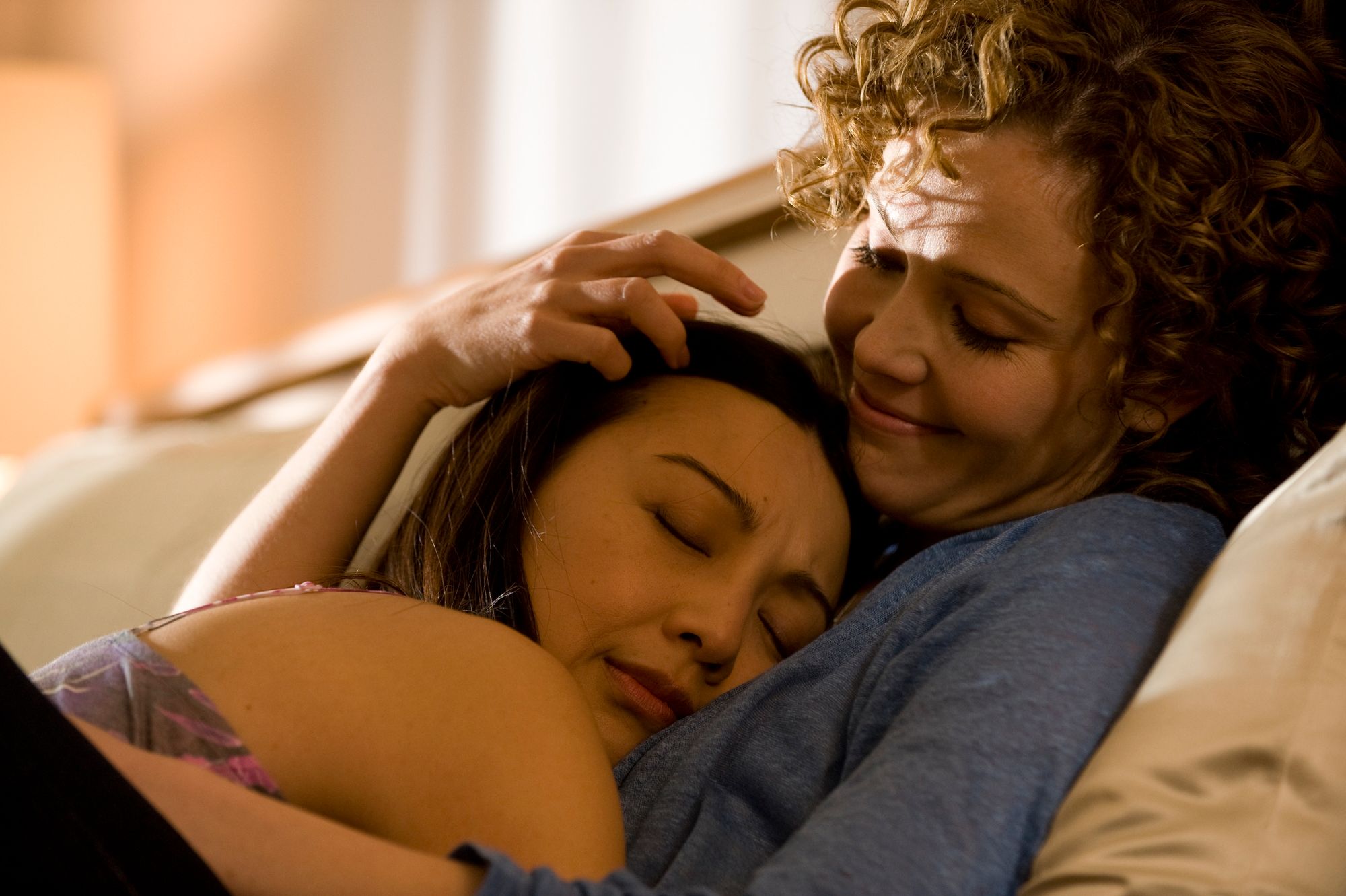Camile Wray (Ming-Na Wen) rests her head on Sharon Walker (Reiko Aylesworth)’s chest.