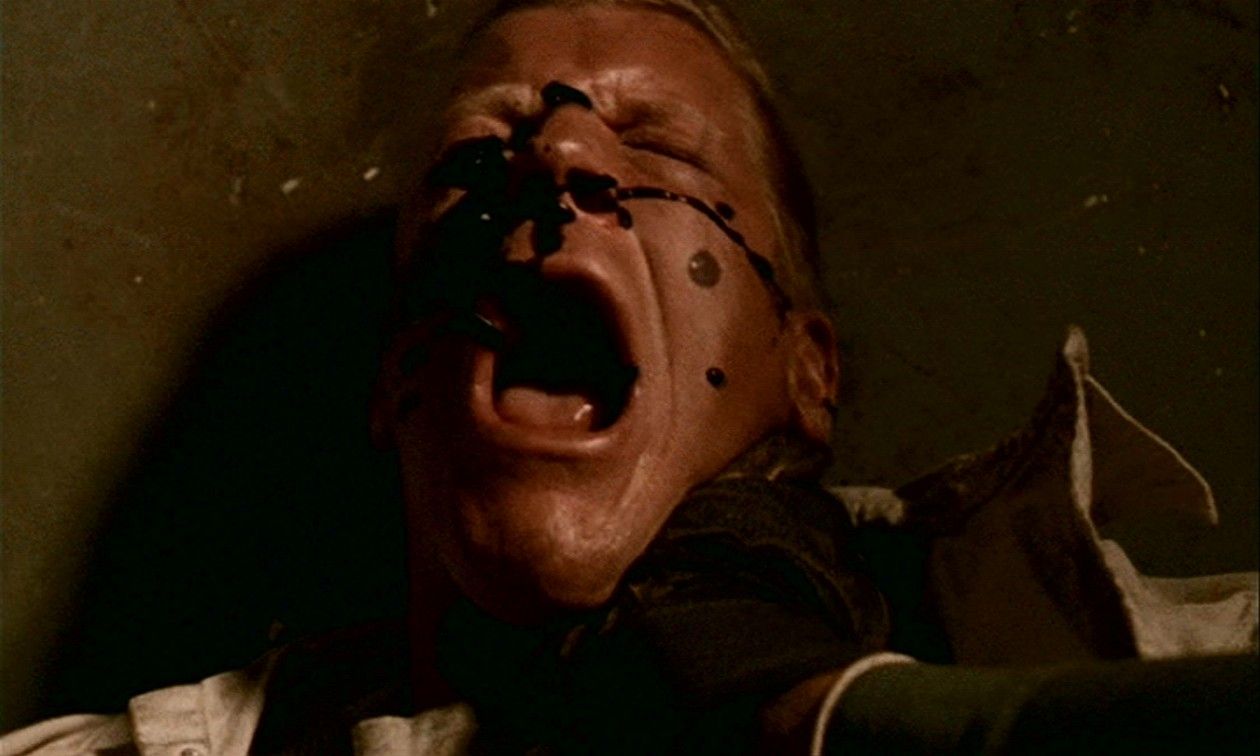 Black Oil drops onto the face of Yuri Volkoff (Lee Reherman), who screams.