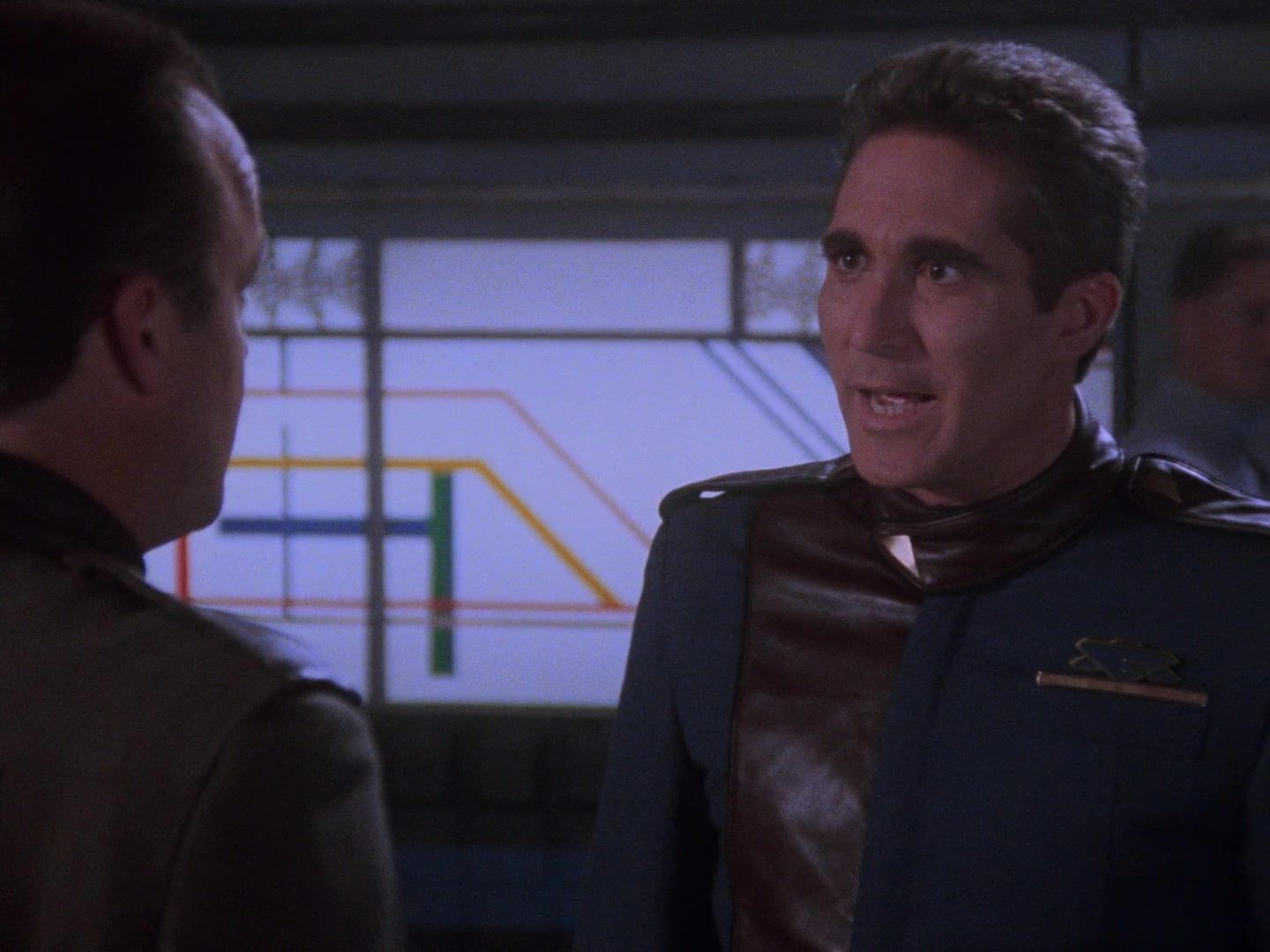 Security chief Michael Garibaldi (Jerry Doyle) listens to Commander Jeffrey Sinclair (Michael O’Hare)