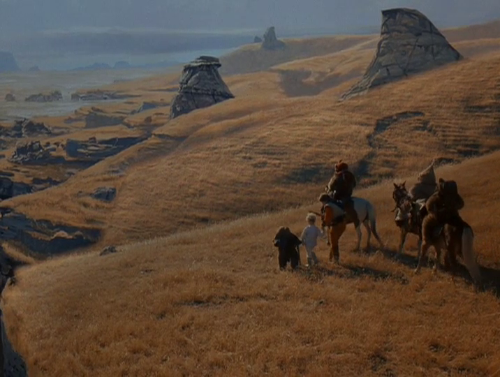 Mace (Eric Walker) and Cindel Towani (Aubree Miller) walk alongside three Ewoks on horseback.
