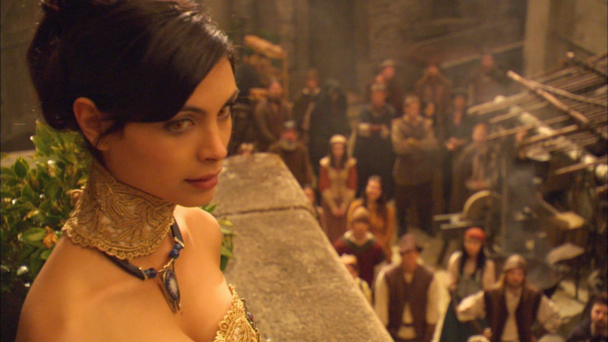 The adult Adria (‎Morena Baccarin) looks out over the crowd.