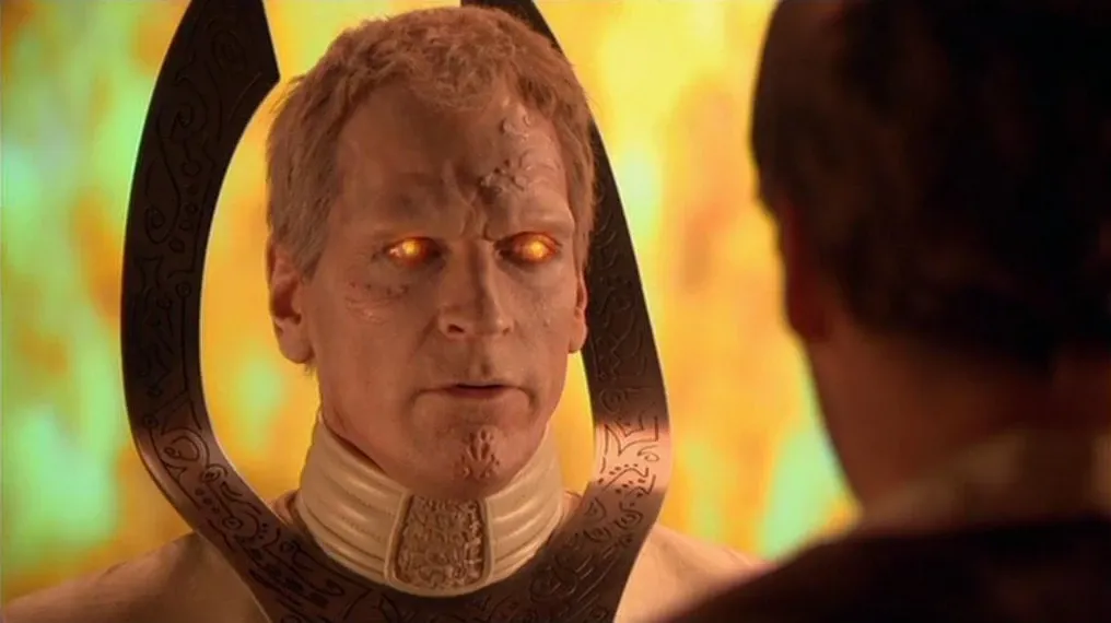 Doci (Julian Sands)'s eyes glow.