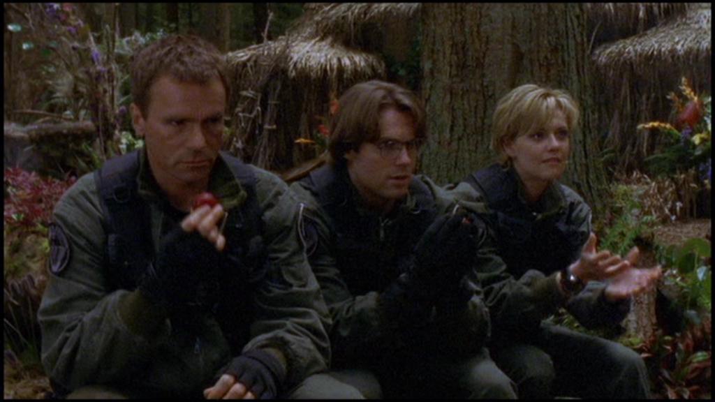 Jack O'Neill, Daniel Jackson, and Samantha Carter, sit under a tree after being rescued from Apophis by the Nox.