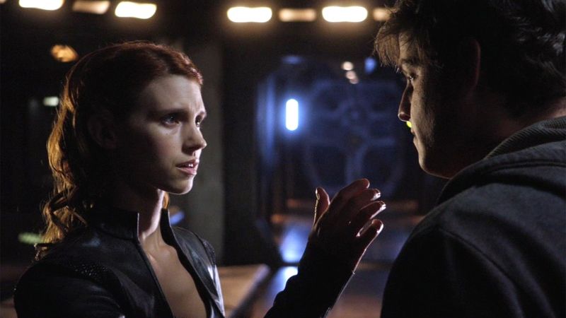 Ginn (Julie McNiven) reaches out to touch Eli (David Blue).