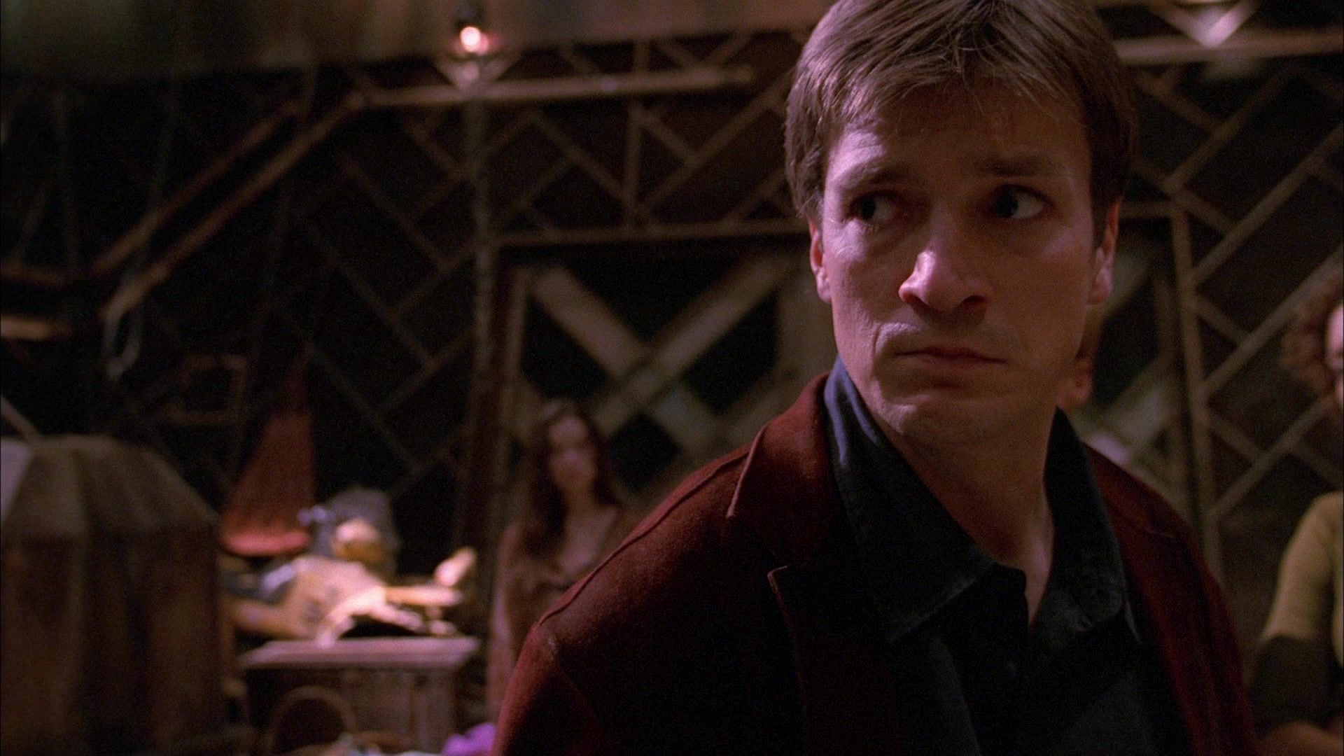Malcolm Reynolds (Nathan Fillion) in the Firefly episode ‘Our Mrs. Reynolds’. Mal is in the hold of Serenity looking serious.