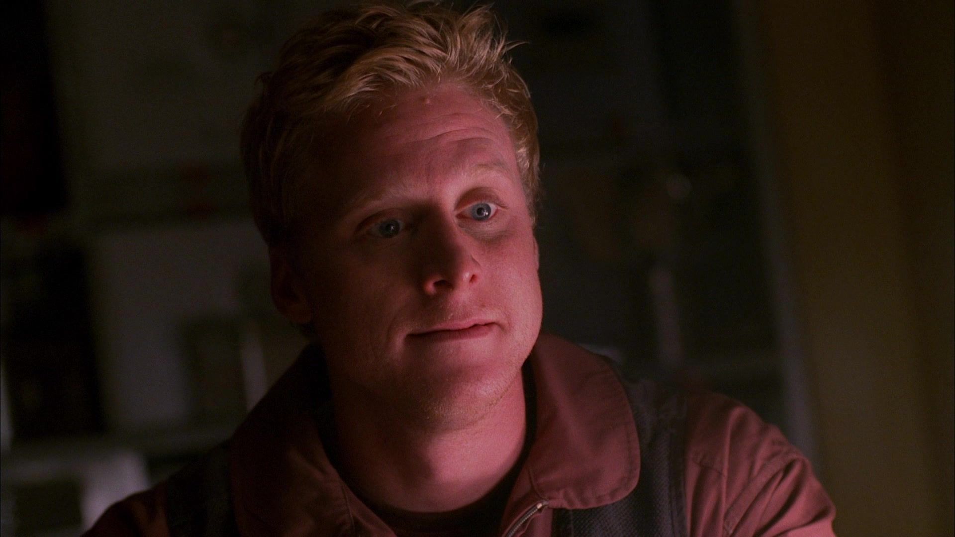 Hoban Washburne (Alan Tudyk) in the Firefly episode ‘Our Mrs. Reynolds’. Washburne is sitting at a table looking blank.