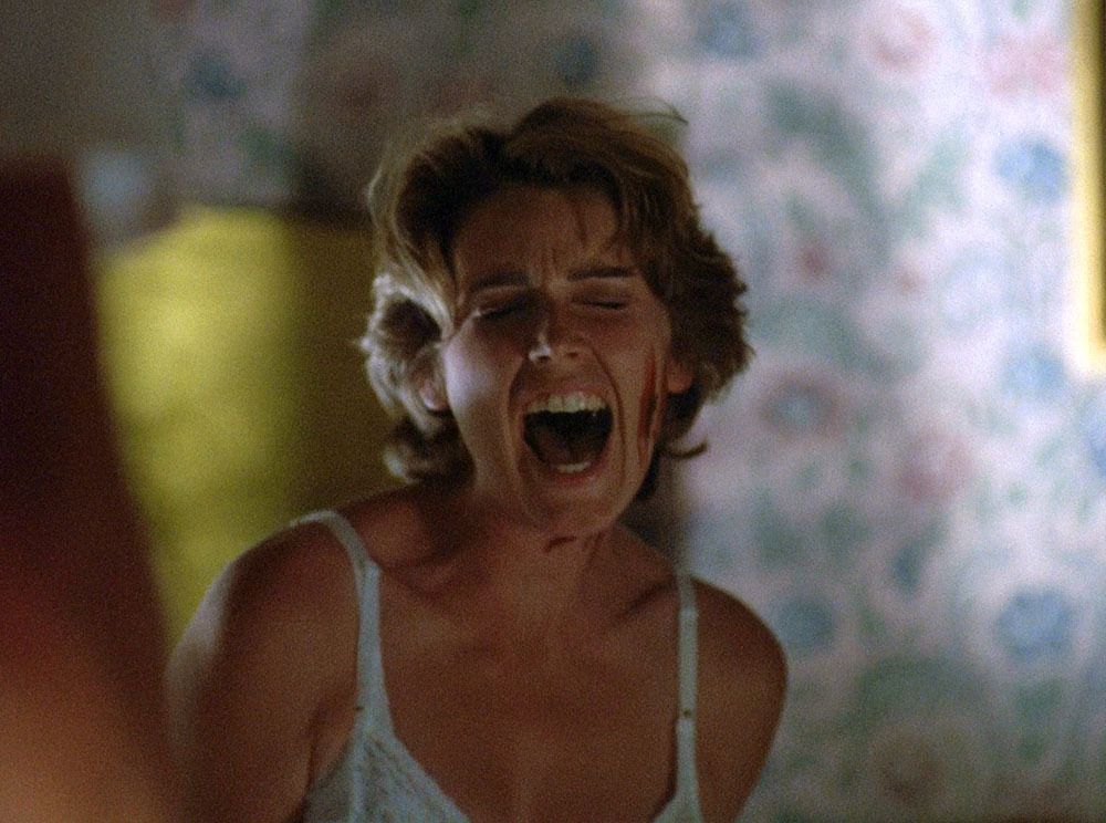 Alia (Renée Coleman) closes her eyes as she screams, her face bloody.