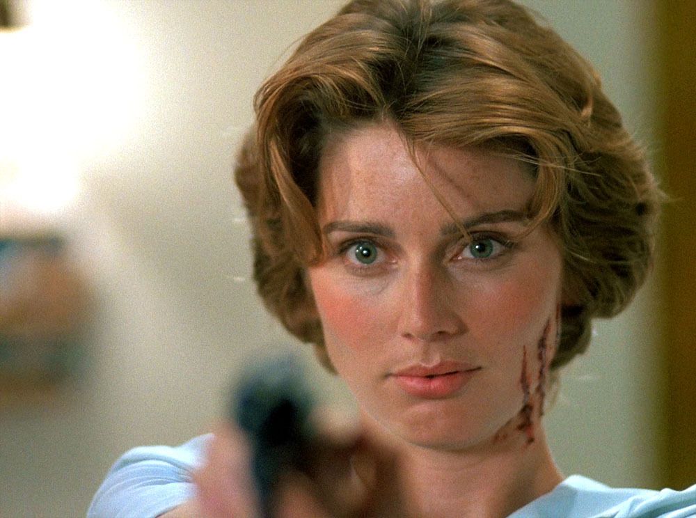 Alia (Renée Coleman) stares down the sight of a revolver.