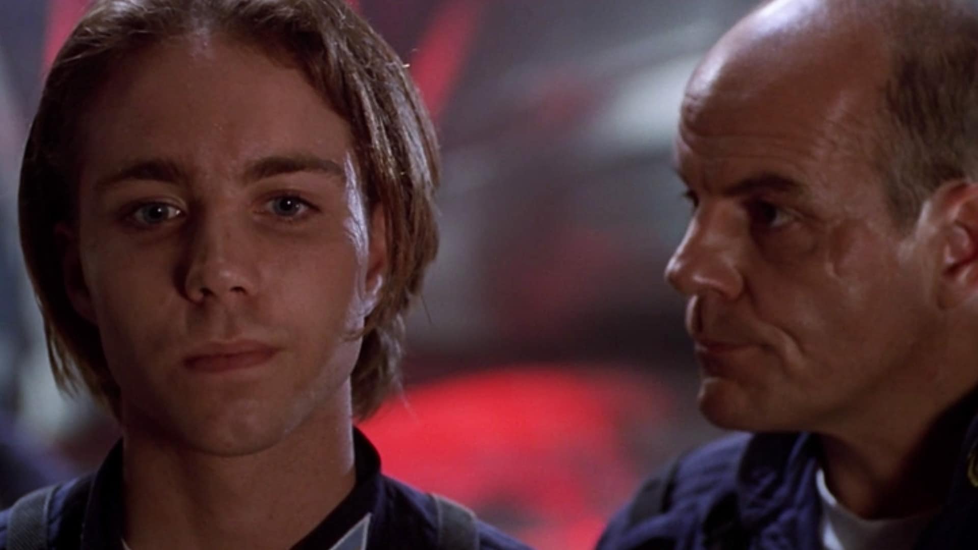 Ensign Lucas Wolenczak (Jonathan Brandis) looks downcast as Captain Oliver Hudson (Michael Ironside) gives him a dressing down.