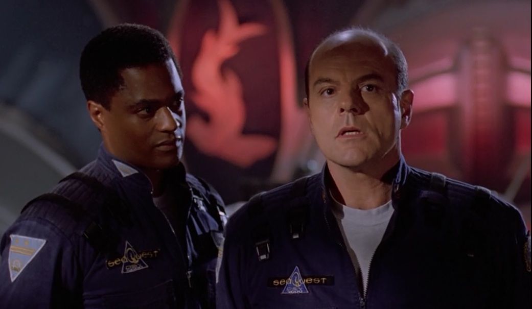 Commander Jonathan Ford (Don Franklin) looks to Captain Oliver Hudson (Michael Ironside)