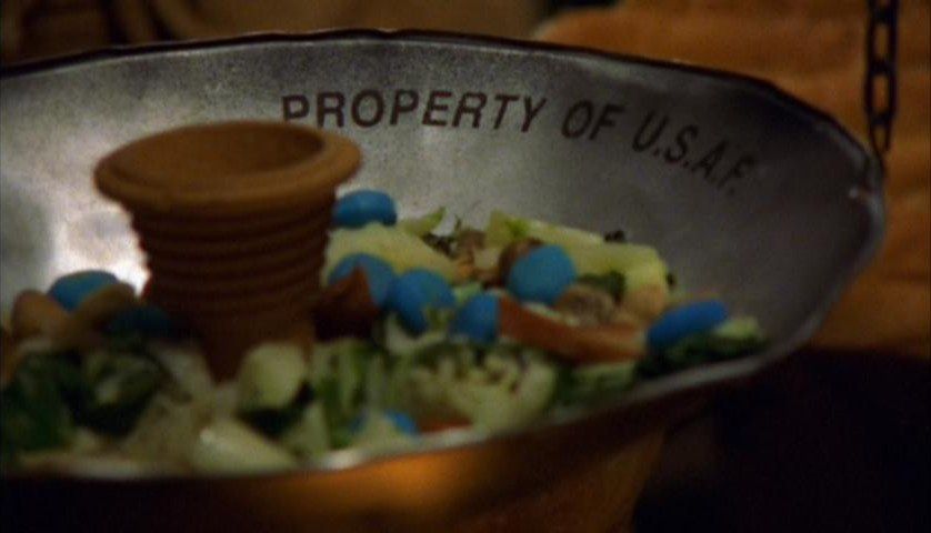 A dish filled with alien vegetables is stamped "Property of USAF"in Stargate SG-1's ‘Children of the Gods: The Final Cut’.