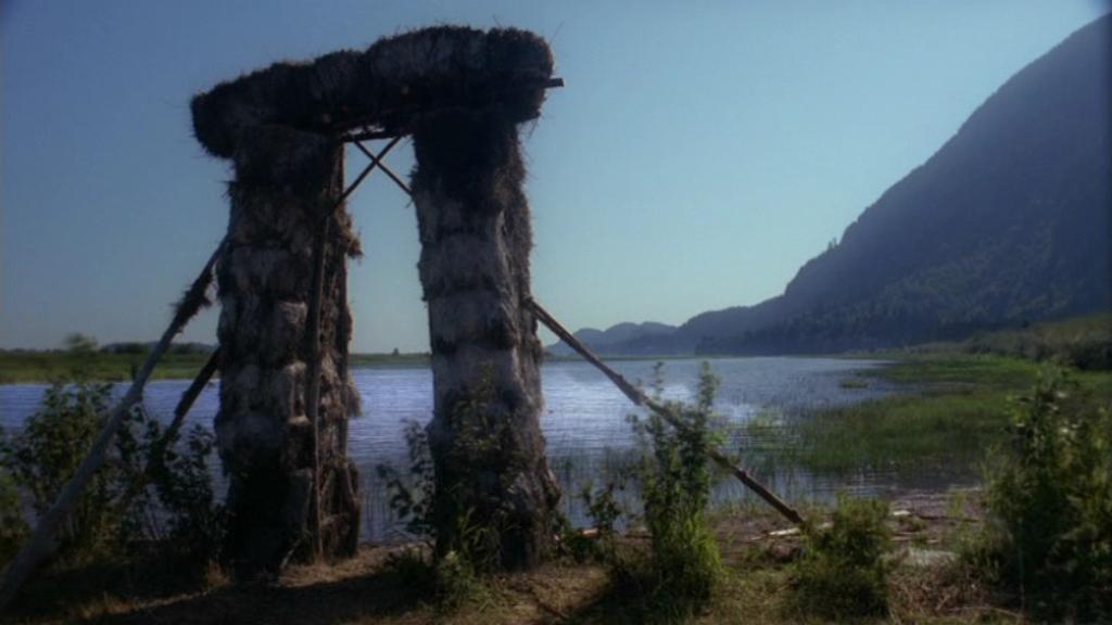 A stone henge overlooking a lake.