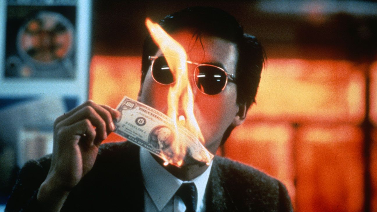 Mark Lee (Chow Yun-Fat) lights his cigarette with a burning US $100 bill.