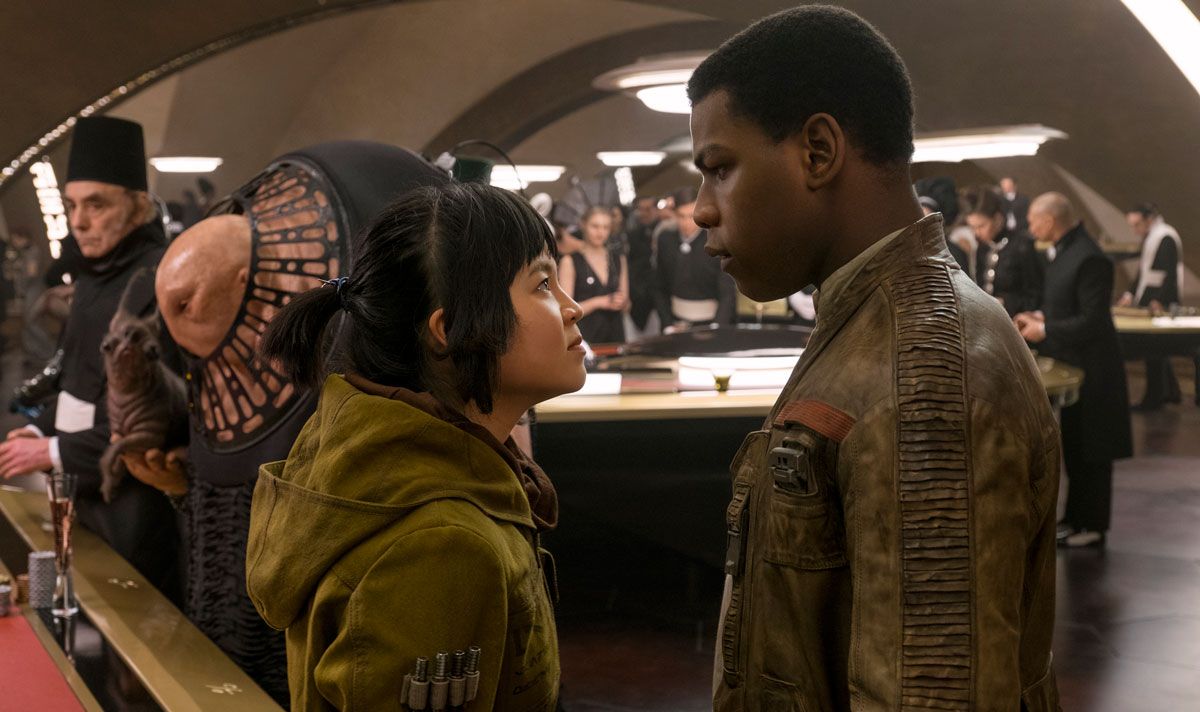 Rose Tico (Kelly Marie Tran) and Finn (John Boyega) face one another.