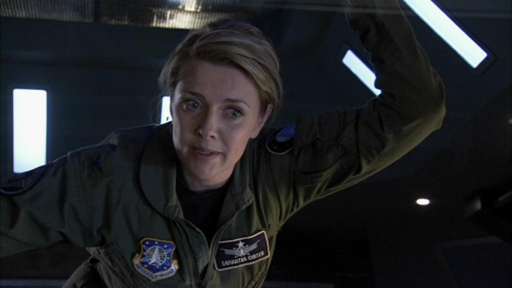 Lt. Col. Samantha Carter (Amanda Tapping) holds onto a ship’s bulkhead.