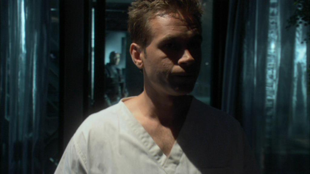 Lt Michael Kenmore (Connor Trinneer) wears a hospital gown.