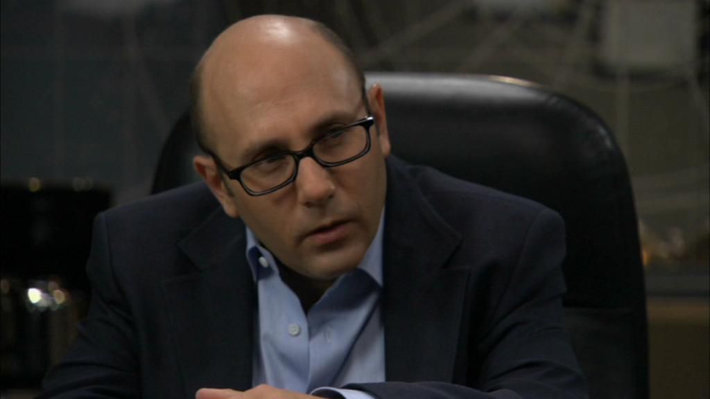 Martin Lloyd (Willie Garson) sits in the conference room.