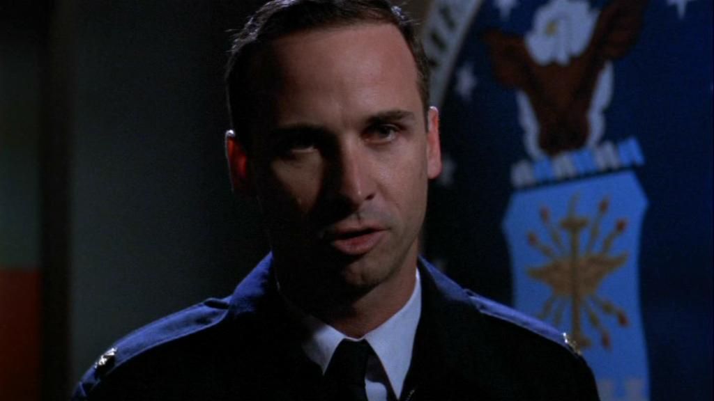 USAF Major Paul Davis (Colin Cunningham) in the Stargate SG-1 episode  ‘A Matter of Time’. Davis wearing his dark blue dress uniform and is addressing General Hammond, who is off-camera.