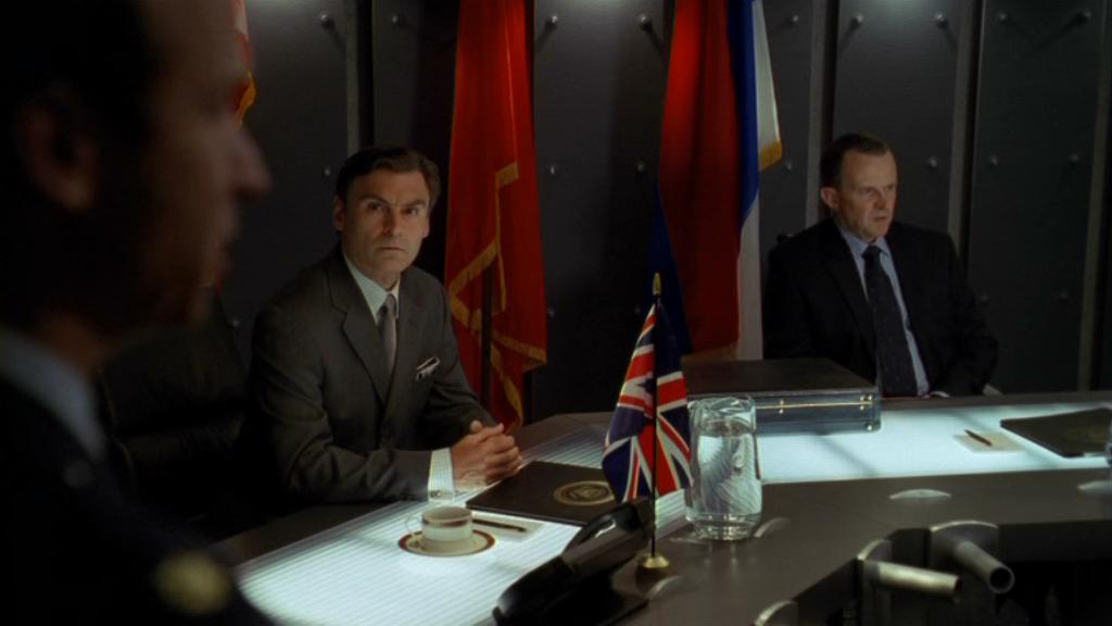 General Hammond speaks to the UN Security Council, the British and French representatives are seated at a table behind him.