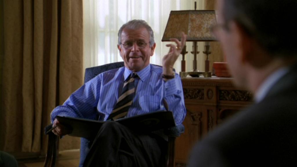 Newly installed President Henry Hayes (William Devane) sitting.