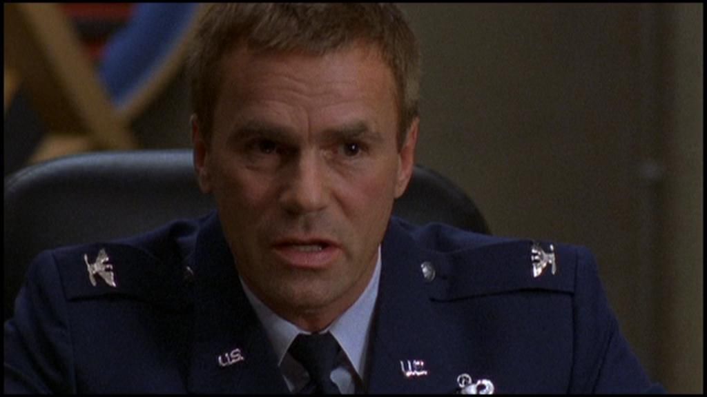Jack O’Neill (Richard Dean Anderson) seated in his dress uniform.