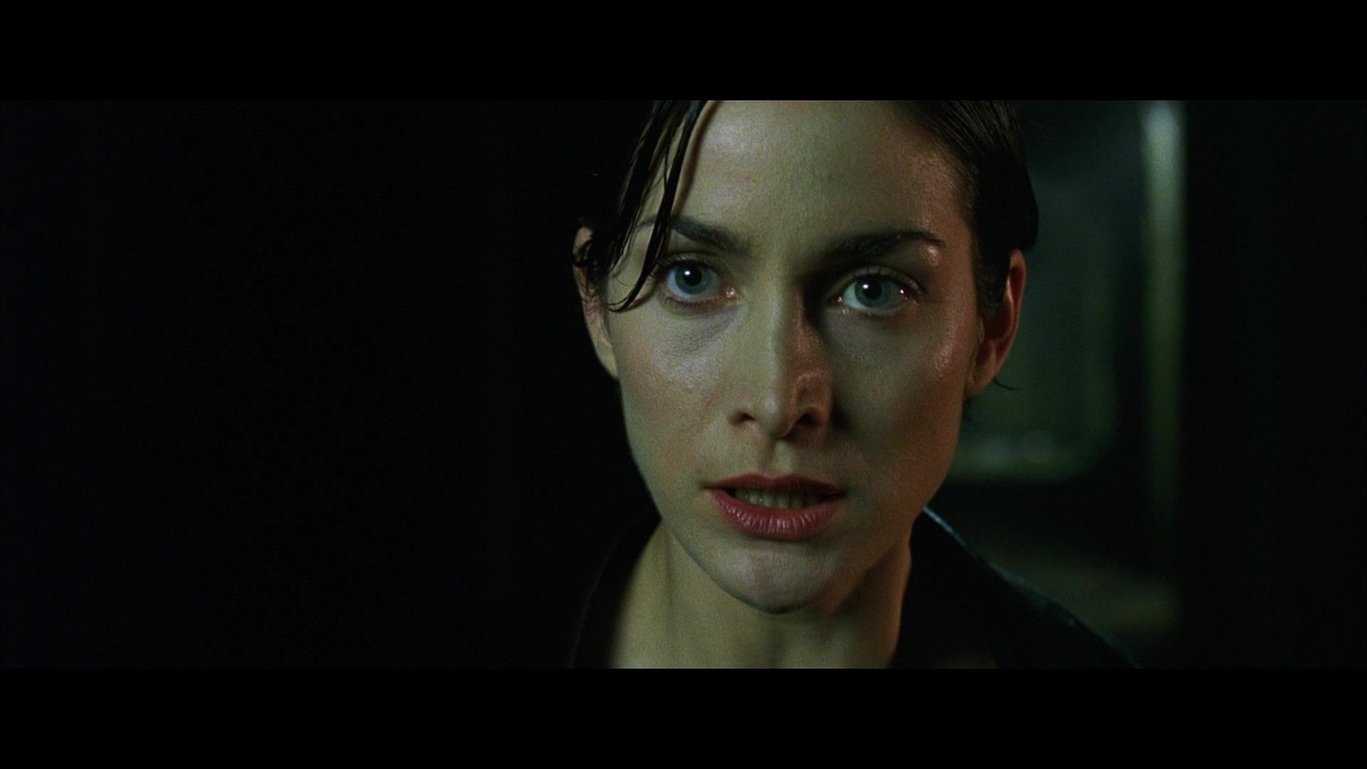 Trinity (Carrie Anne Moss) in close-up.