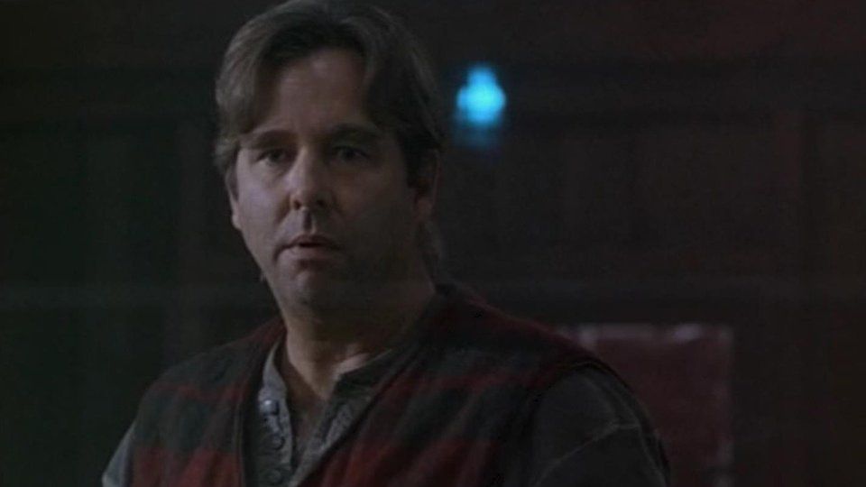 Dr. Simon Kress (Beau Bridges) in grey shirt and sleeveless vest.