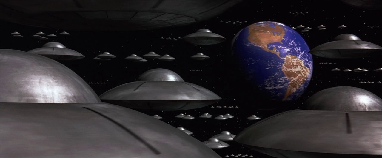 Flying saucers head towards Earth.