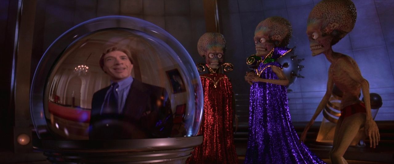 Robed Martians watch Jerry Ross (Martin Short) through a viewing orb.