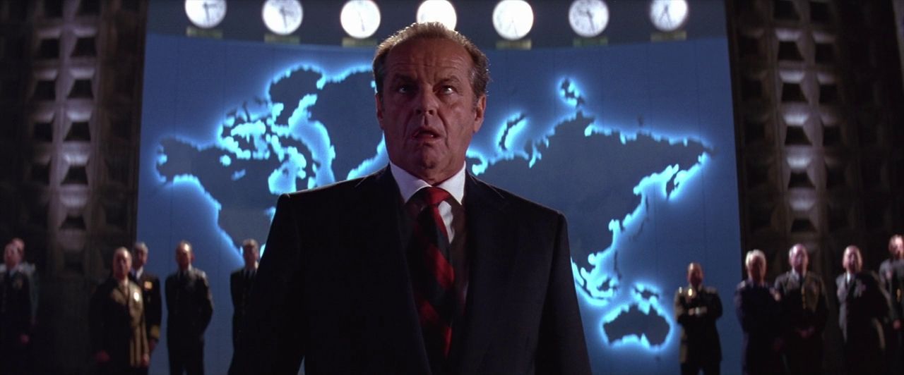 US President James Dale (Jack Nicholson) in a control room with a map of the globe behind him.