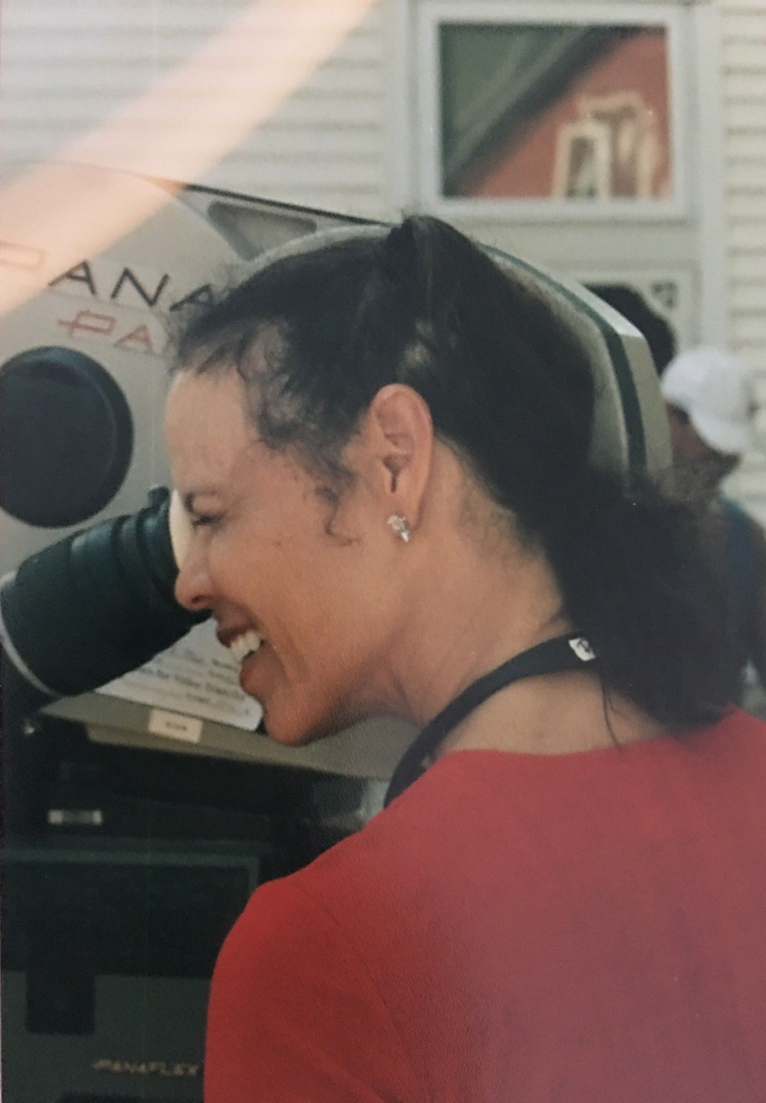 Deborah M. Pratt smiles as she looks through the camera lens.