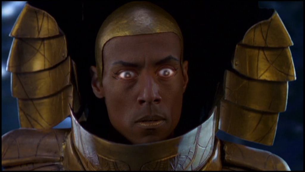 Apophis's gold cobra-like helmet is open, revealing his face.