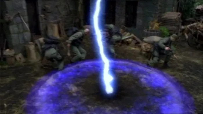 A bolt of blue lightning strikes the centre of the courtyard in Stargate SG-1 episode 'Demons' (S3, Ep8). Jack O'Neill, Daniel Jackson, Samantha Carter, and Teal'c can be seen recoiling from the impact.