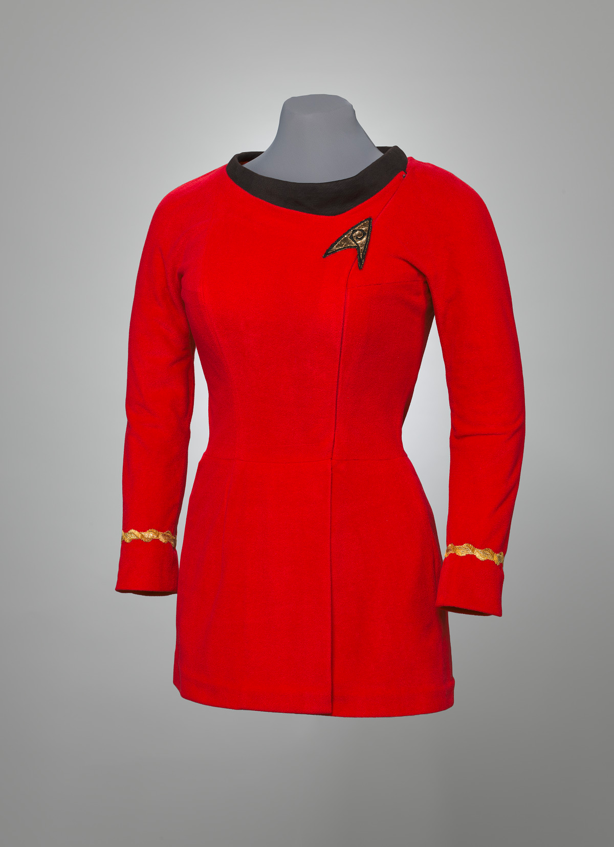 Uhura's red mini-dress with gold trip and a black collar on a dummy.