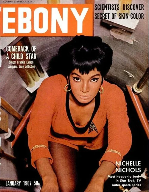 The cover of Ebony magazine showing Nichelle Nichols climbing up a ladder in her red minidress.